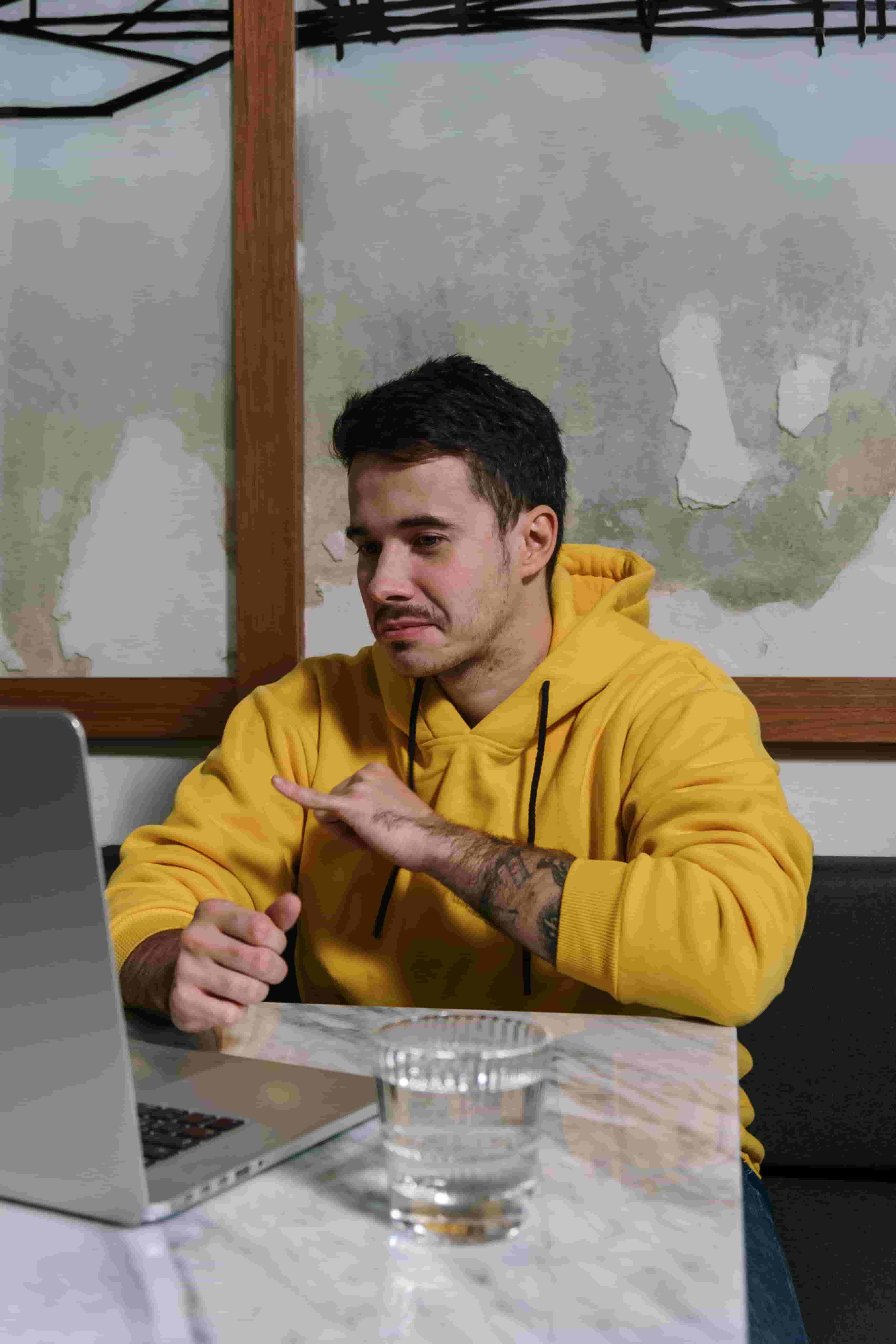 Person practicing language with AI on laptop in a comfortable setting