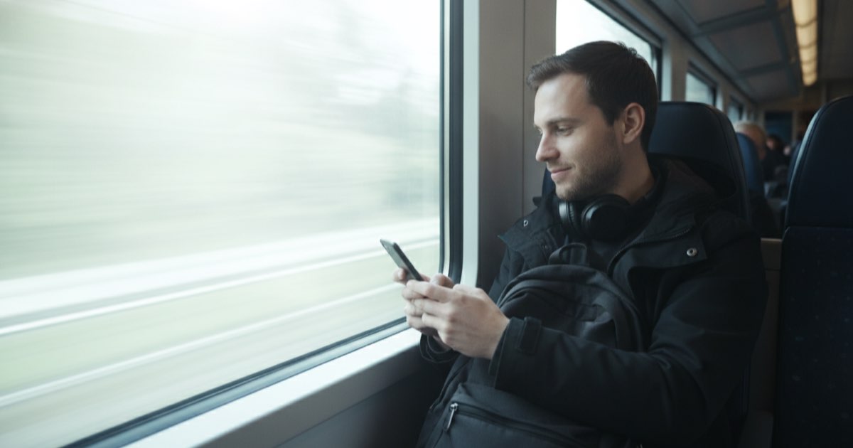 Language learner practicing English vocabulary alone on a phone during a morning commute